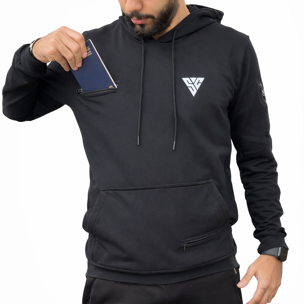 Man wearing a black SunCloud travel hoodie using a hidden chest zip pocket